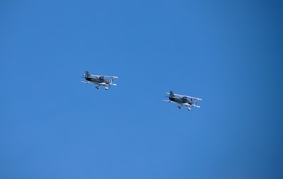 white jet plane in mid air during daytime